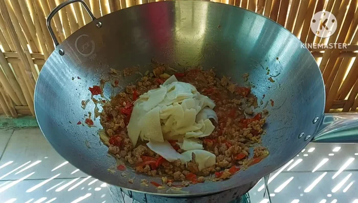 Add blanched bamboo shoots and stir-fry until everything is combined.