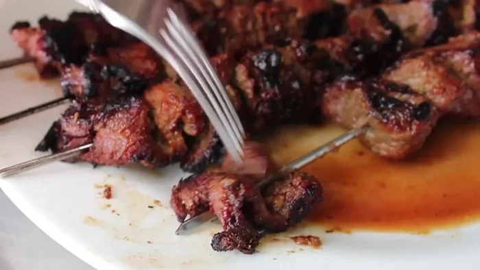 Rest and serve: Remove the skewers from the grill and let them rest for a minute. Serve immediately with peanut sauce (recipe in a separate video).