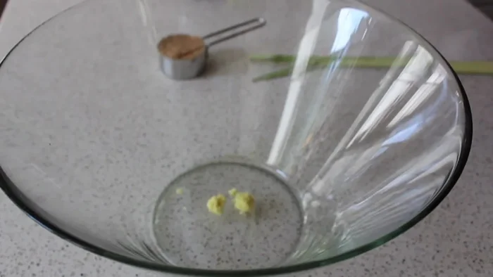 Prepare the marinade: In a mixing bowl, combine freshly grated ginger (using a microplane), crushed garlic, minced onion, brown sugar, fish sauce, vegetable oil, soy sauce, ground coriander, ground cumin, turmeric, and cayenne pepper. Mix well.