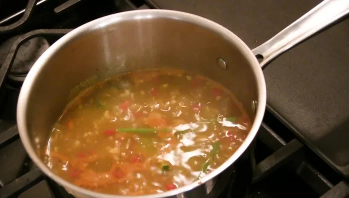Add the minced lemongrass to the simmering stock.