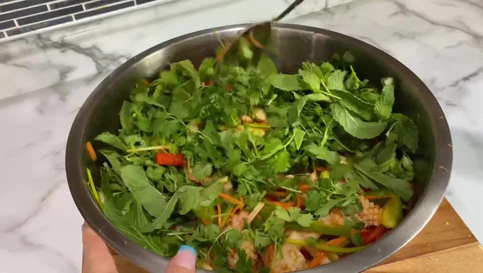 Add herbs, gently mix, and transfer to a serving dish.