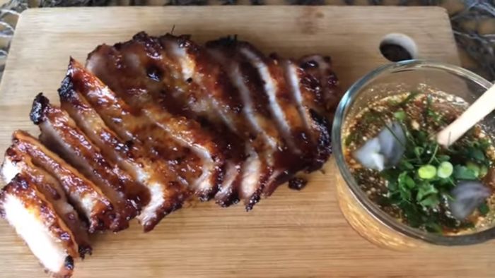Serve: Slice the grilled pork and serve with the Nam Jim Jaew dipping sauce and sticky rice.