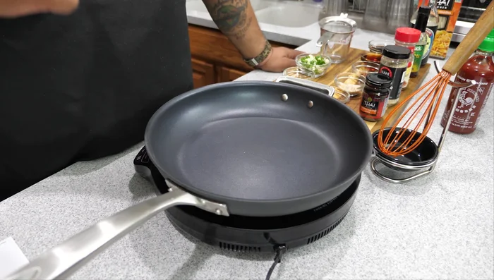 While noodles are cooking, heat sesame oil and canola oil in a pan over medium-high heat.