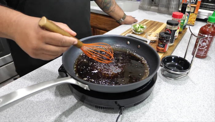 Once noodles are cooked, drain them using a colander. Add the cooked noodles to the sauce and toss to coat.