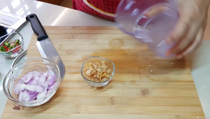 Wash the dried prawns with hot water and grind them using a grinder or mortar and pestle.
