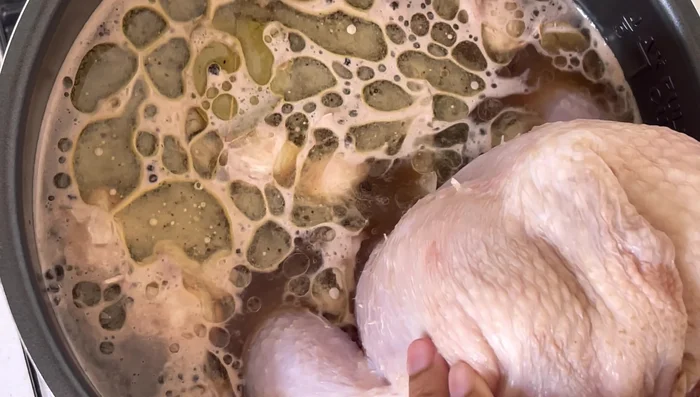 Clean and pat the chicken dry. Place chicken breast-side down in the brine pot. Add a plate on top to keep chicken submerged. Seal the pot and refrigerate overnight.