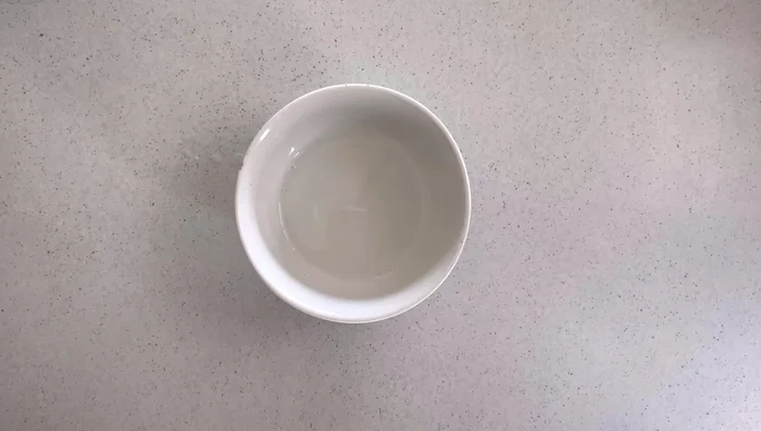 Mix cornflour with a little cold water to form a slurry. Slowly add this slurry to the sauce while stirring to prevent lumps. Cook until thickened.