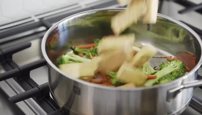 Add tofu and sauté for 1 minute (120.149). Set aside veggies. Turn heat to medium (123.49).