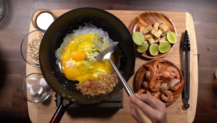 Cook the eggs: Add eggs to the wok and scramble until cooked, then remove to the side.