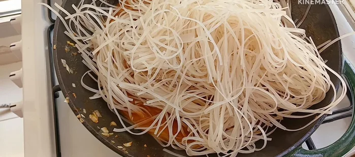 Add rice noodles and stir well to combine with the sauce.