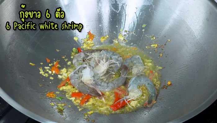 Add shrimp and squid to the wok and stir-fry until they change color.