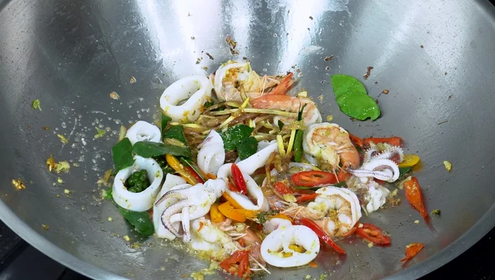 Add oyster sauce, fish sauce, green soy sauce, and sugar. Stir-fry to combine.