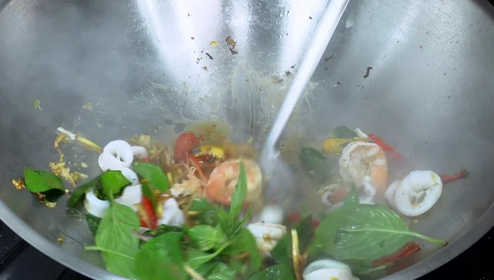 Add basil leaves and stir-fry until wilted.