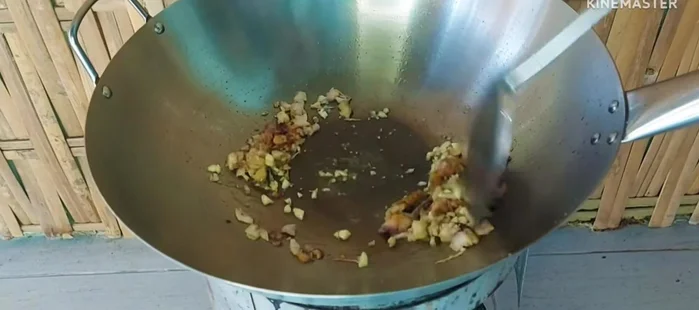 Add chopped garlic and stir-fry until slightly yellow. The garlic's aroma will help mask the fishy smell.