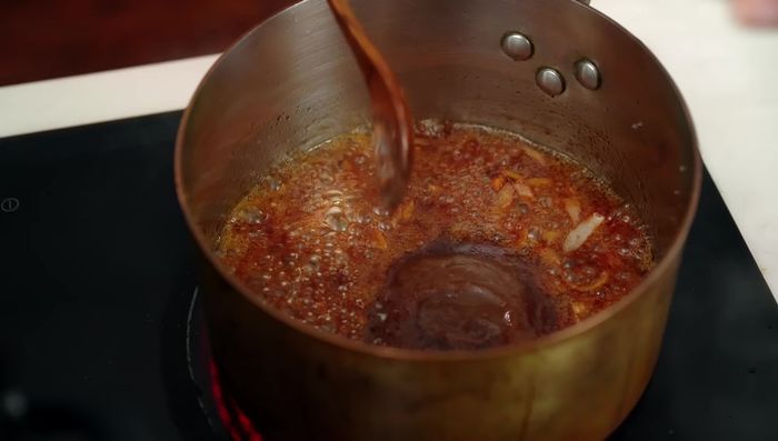 Stir in fish sauce, tamarind paste, and chili powder. Simmer until flavors meld and the sauce thickens slightly; add a little water to adjust consistency.