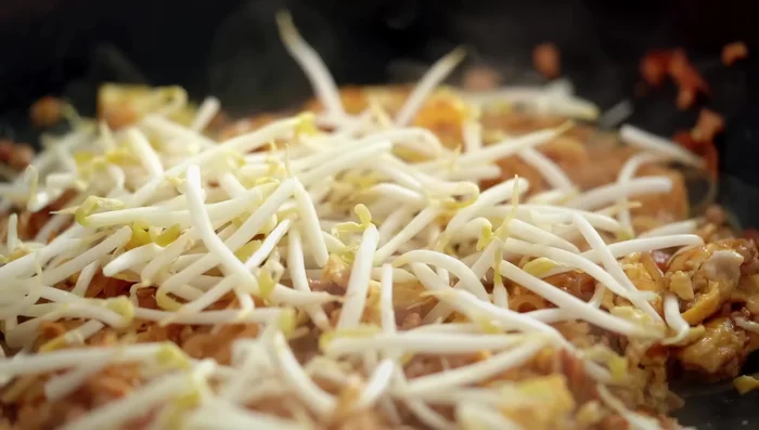 Stir in bean sprouts and spring onions.