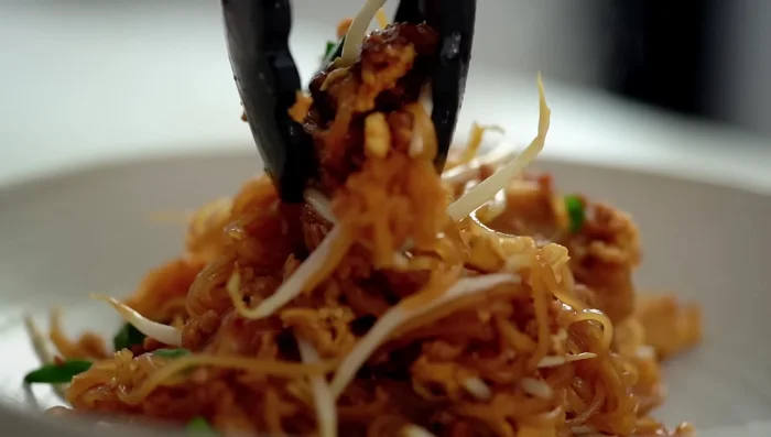 Serve immediately, garnished with extra spring onions and a lime wedge.