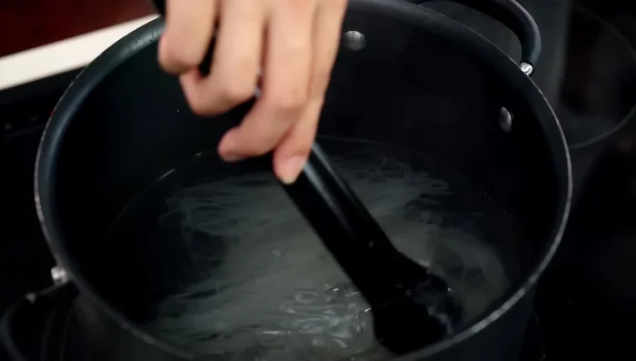 Soak very thin rice noodles in hot (not boiling) water until tender but slightly al dente.