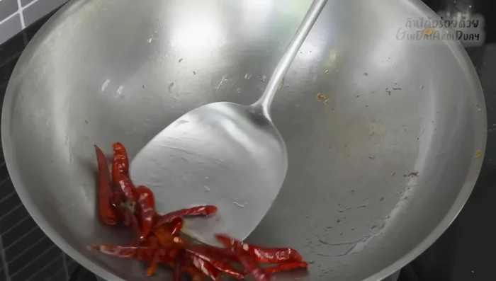 Fry the chilies: Add oil to the same pan and fry the dried chilies until fragrant.