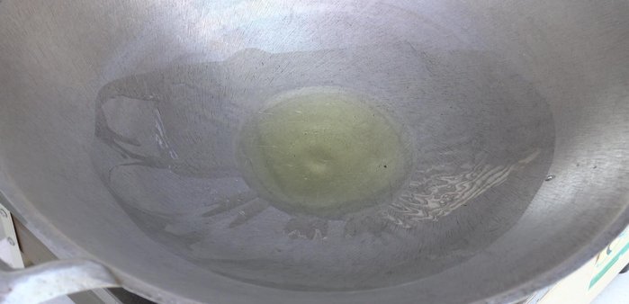 Heat oil in a pan. Add red curry paste and chili peppers, stir-fry until fragrant.