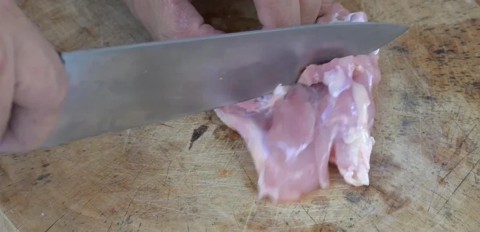 Remove bones from chicken thighs. Cut into bite-sized pieces, keeping the skin attached.
