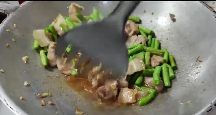 Continue stir-frying until the yardlong beans are cooked through. Adjust water as needed.