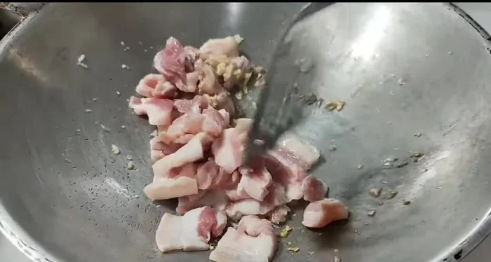 Add the pork belly and stir-fry until cooked.