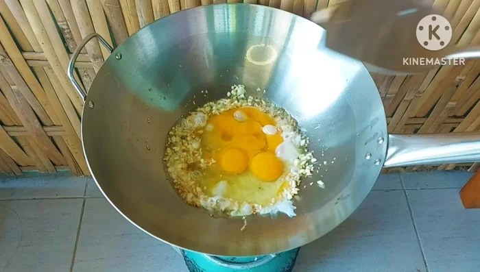 Add the eggs to the pan and stir-fry until they are lightly cooked, but not mushy.