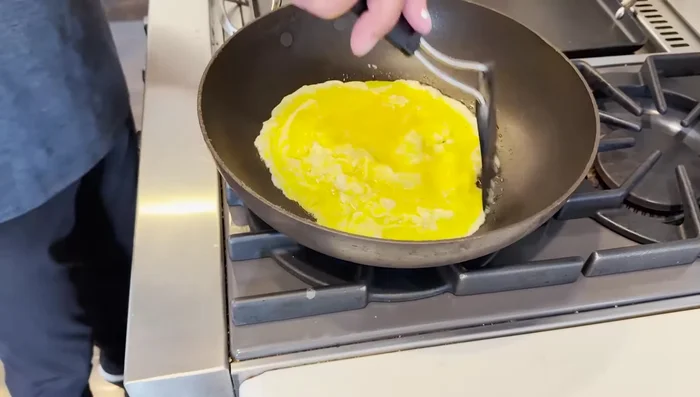 Continue this process until the omelette is mostly cooked but still slightly runny in the center.