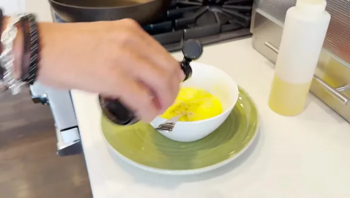 Add a dash of fish sauce to the whisked eggs.