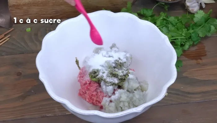 Add the herb paste, salt, sugar, soy sauce, oyster sauce, sesame oil, mushrooms, egg white, and cornstarch to the stuffing. Mix well until sticky.