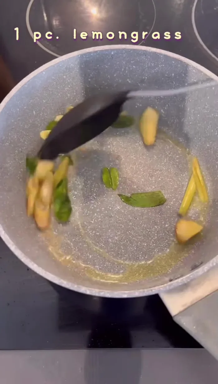 Prepare Tom Yum soup: Fry garlic, lemongrass, galangal, red onion until fragrant. Add water, salt, sugar, bring to a boil. Add fish, fish sauce, red onion, mushrooms. Once cooked, add chilies and Thai basil. Stir in lime juice and dried chilies.