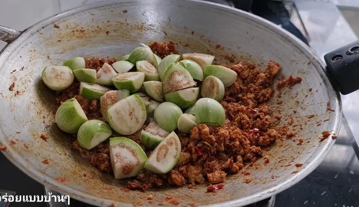 Add eggplant, galangal, and pepper; stir-fry until eggplant is crispy.