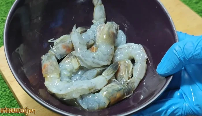 Clean the shrimp, remove the shells, and straighten out the back line.