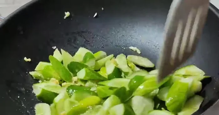 Add the cucumbers to the pan and stir-fry until cooked.