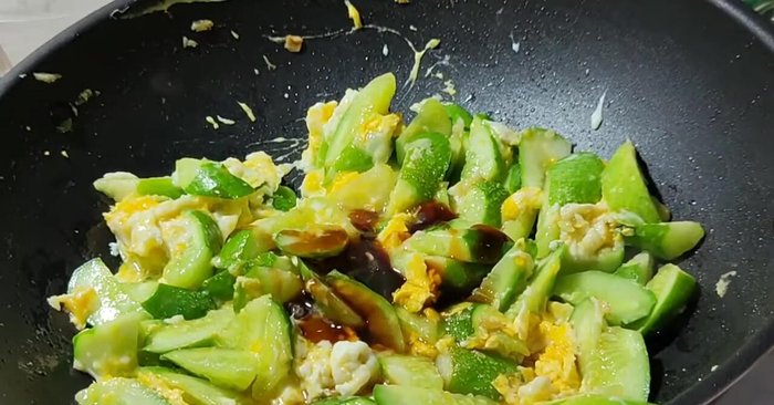 Season with sugar, soy sauce, and oyster sauce. Stir-fry until well combined. Add chili if desired.