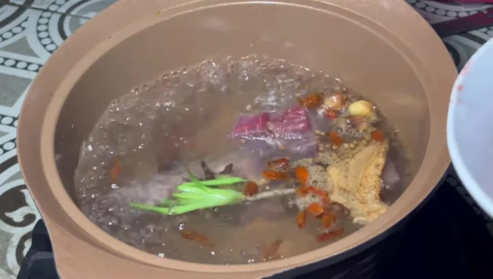 Add the bones, meat, and fat to the pot.
