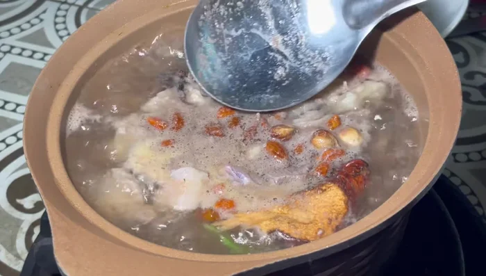 Skim off the foam from the surface.