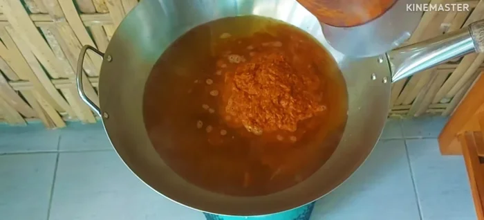 Add the blended mixture back to the pot. Add half of the canned fish.