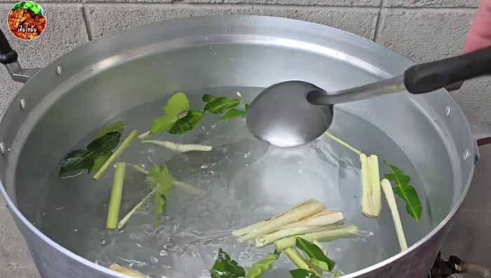 Boil the pork filling with lemongrass, kaffir lime leaves, and salt for 10-15 minutes until cooked.