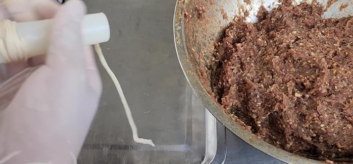Stuff the mixture into cleaned beef or pork intestines using a cone or similar tool.