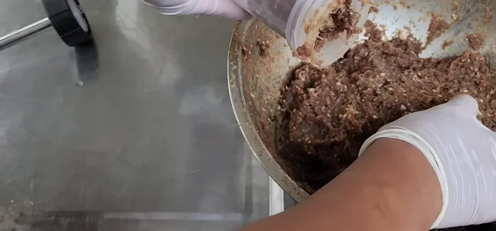 Tie off both ends of the stuffed intestines, ensuring that they are tied tightly and securely. Leave a little space at the end to allow for expansion during drying. Poke the sausage to expel any trapped air.