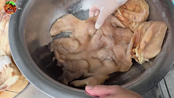 Apply the marinade thinly to the pig mask, avoiding excess.