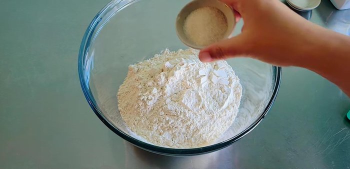 Mix flour ingredients: Combine flour, sugar, salt, water, and 100 grams of vegetable oil. Knead until dough forms. (47.399)