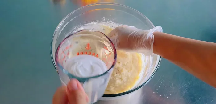 Gradually add coconut milk (4-5 tablespoons), mixing until well combined. The mixture should not be too watery.