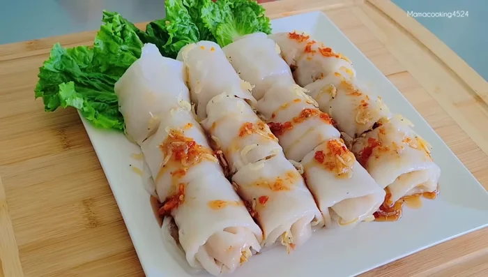 Serve: Pour the dipping sauce over the rolled noodles (595.839). Garnish with pork rinds (619.079).