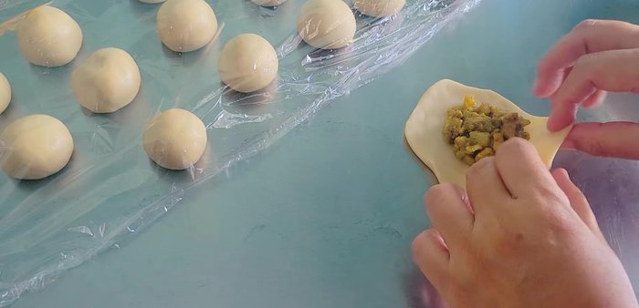 Seal the puffs: Bring the edges of the dough together and pinch to seal. Pleat the edges for a decorative finish.