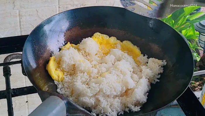 Add rice and stir-fry with eggs.
