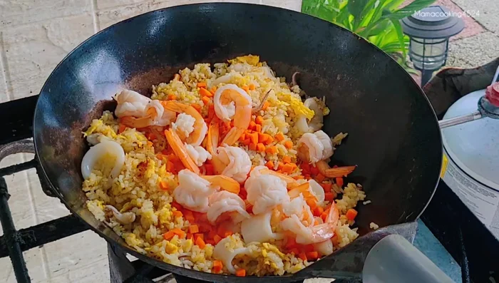 Add spring onions and stir-fry until everything blends well.