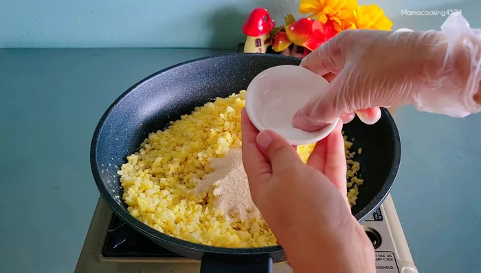 Add boiled mung beans, sugar, and salt to the garlic-pepper mixture. Stir-fry and mash the beans until well combined and forms a lump.